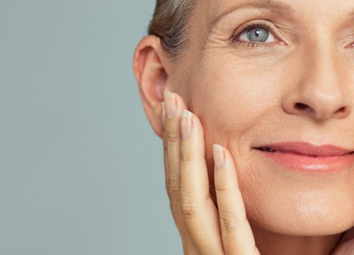 Older woman touching her face after Active FX treatments