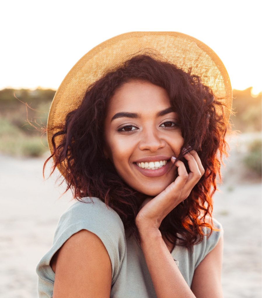 Woman in a sun hat on the beach