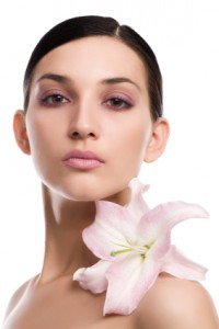 Brunette woman with a flower on her shoulder