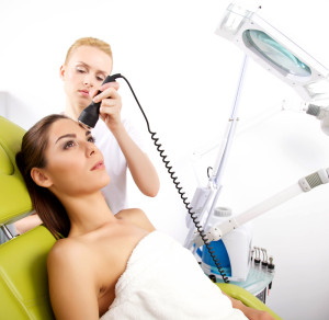 Woman receiving laser brown spot removal treatments