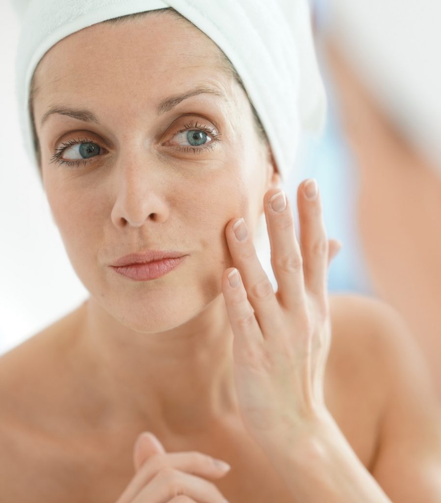 Older woman applying a facial cream