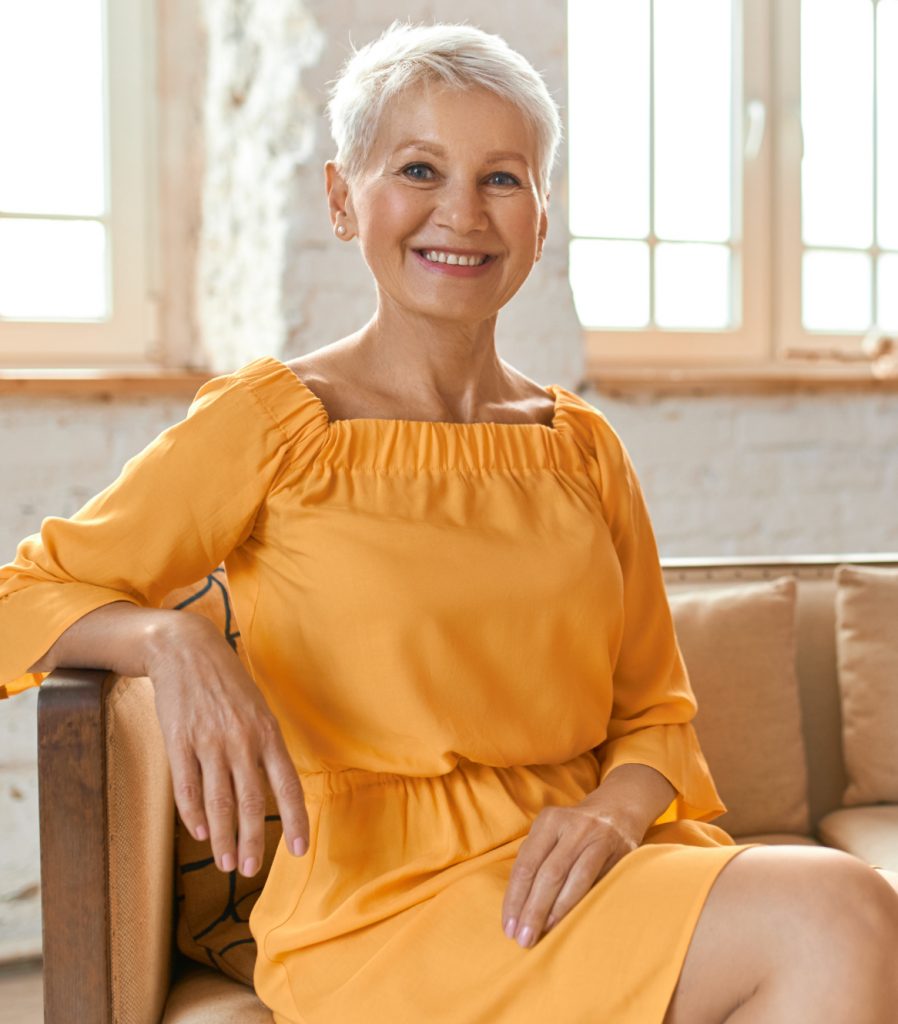 Older woman in an orange outfit
