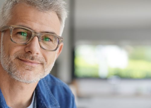 Older man with gray hair and glasses