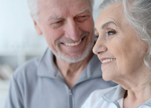 Older man and woman standing next to each other