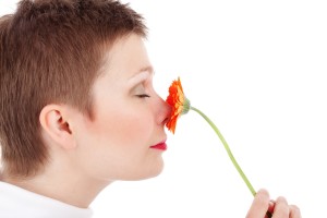 Woman sniffing a flower
