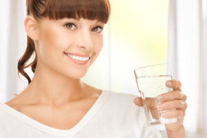 Woman holding a glass of water