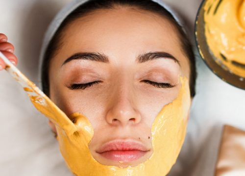 Applying hydrojelly masks to a woman's face