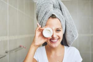 Woman holding up soap in the bathroom