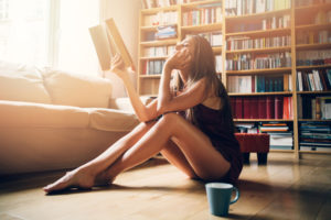 Woman reading a book in her apartment