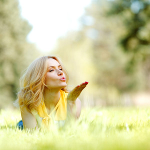 Blonde woman in a grassy field
