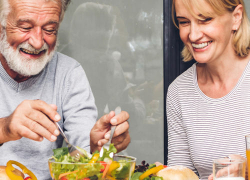 Older man and woman eating a salad