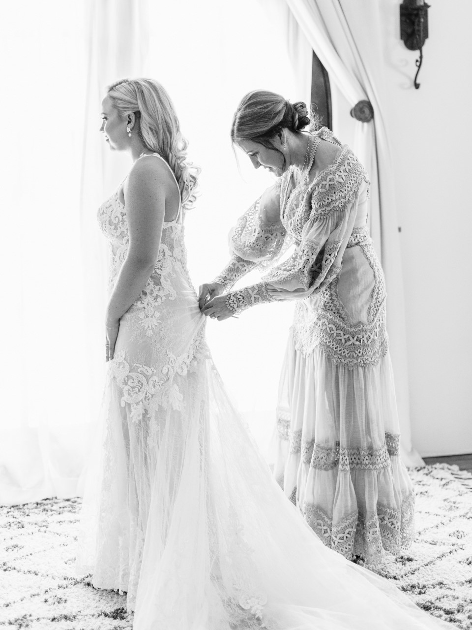 Dr. Behr tying her daughter's wedding dress