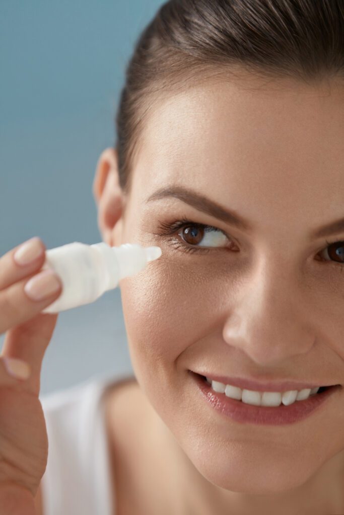 Woman applying eyedrops