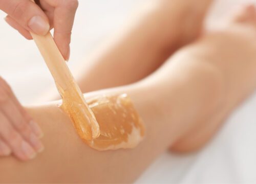 Woman receiving waxing services on her leg