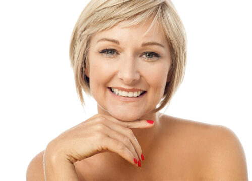Middle age woman with short blonde hair and flawless skin